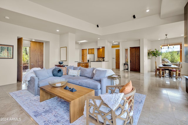 living area with recessed lighting, a notable chandelier, and a healthy amount of sunlight