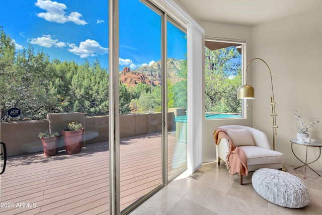 doorway to outside featuring a mountain view, visible vents, and tile patterned floors