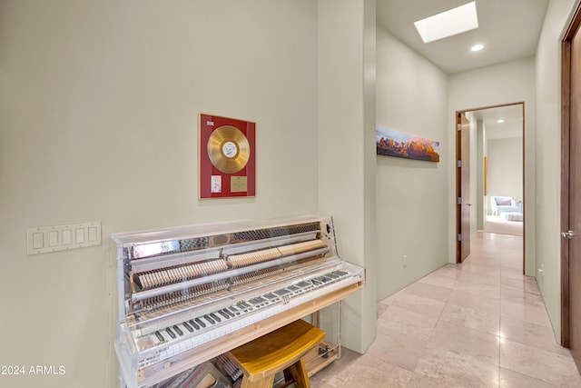 hall featuring recessed lighting and a skylight