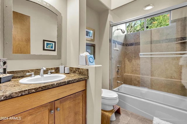 bathroom featuring washtub / shower combination, vanity, and toilet