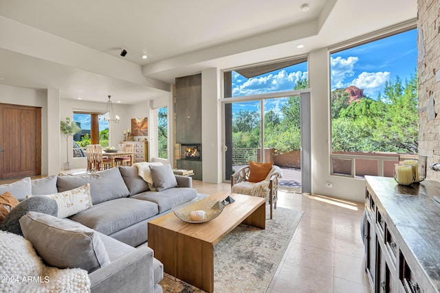 living area featuring light tile patterned floors, recessed lighting, and a fireplace
