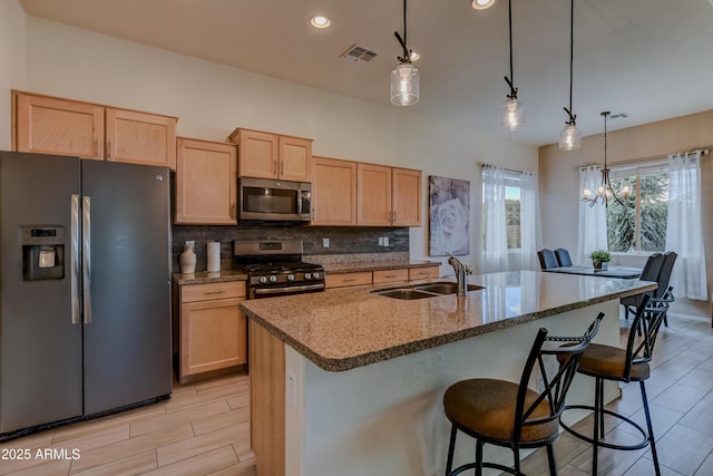 12935 E Ramos St, Dewey, AZ 86327 - kitchen featuring appliances with stainless steel finishes, a sink, light brown cabinets, stone counters, and decorative backsplash