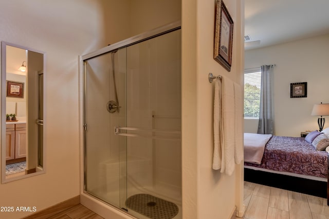 12935 E Ramos St, Dewey, AZ 86327 - ensuite bathroom featuring a stall shower, vanity, and wood finished floors