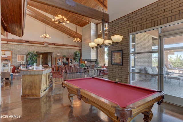 12935 E Ramos St, Dewey, AZ 86327 - recreation room with a chandelier, high vaulted ceiling, brick wall, wood ceiling with exposed beams, and concrete floors