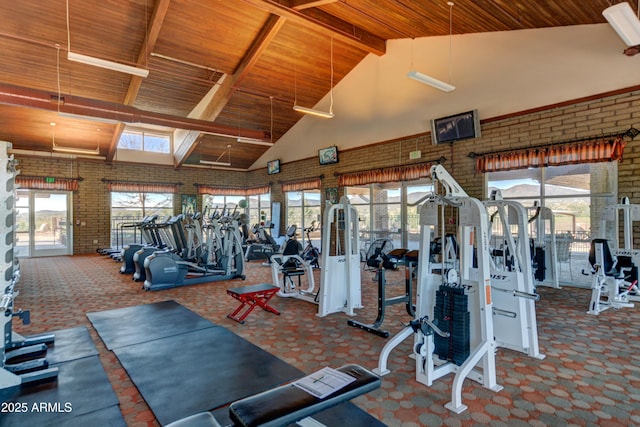12935 E Ramos St, Dewey, AZ 86327 - workout area featuring wood ceiling with exposed beams, high vaulted ceiling, carpet floors, and brick wall