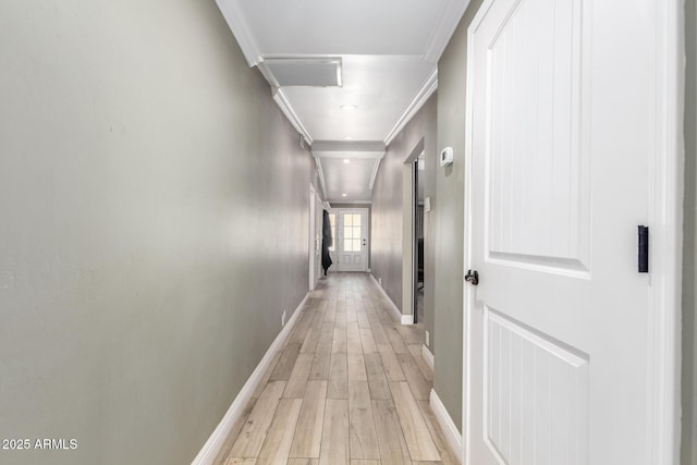 hall featuring light hardwood / wood-style flooring and crown molding