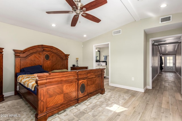 bedroom with ceiling fan, light wood-type flooring, ensuite bathroom, and vaulted ceiling