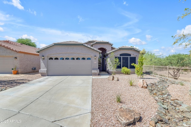 4301 E Abraham Ln, Phoenix, AZ 85050 - mediterranean / spanish home featuring an attached garage, concrete driveway, and stucco siding