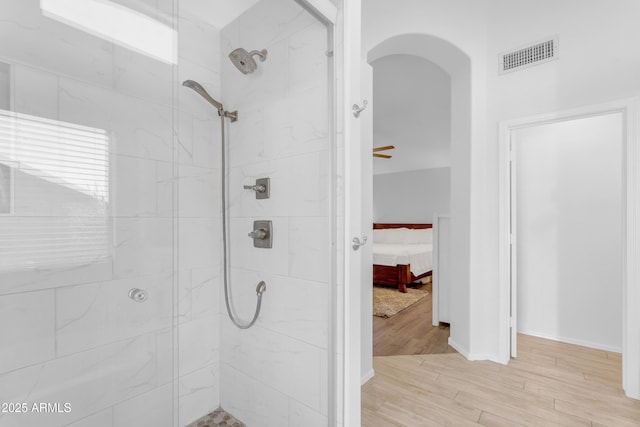 4301 E Abraham Ln, Phoenix, AZ 85050 - ensuite bathroom with tiled shower and wood finished floors