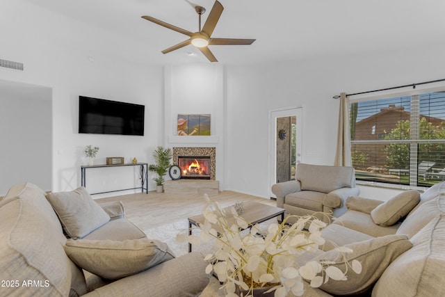4301 E Abraham Ln, Phoenix, AZ 85050 - living area with a ceiling fan, a glass covered fireplace, and wood finished floors
