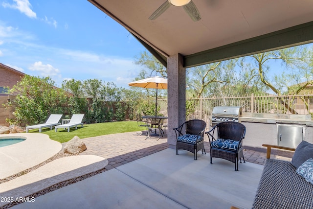 4301 E Abraham Ln, Phoenix, AZ 85050 - fenced backyard with exterior kitchen, ceiling fan, a patio, and outdoor dining space