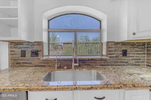 4301 E Abraham Ln, Phoenix, AZ 85050 - kitchen featuring white cabinetry, light stone counters, and tasteful backsplash
