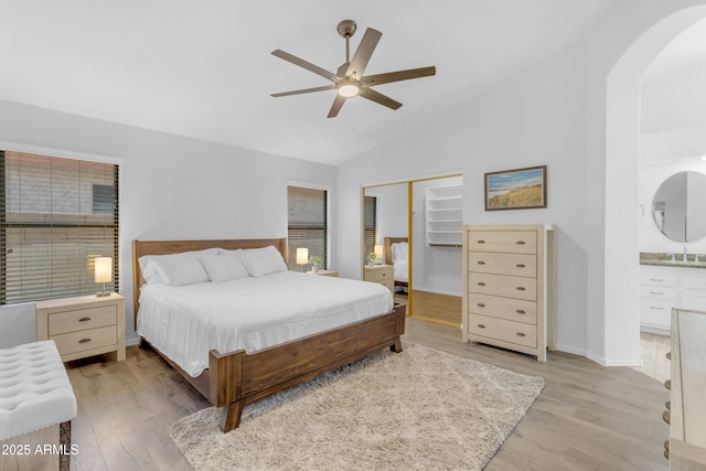 4301 E Abraham Ln, Phoenix, AZ 85050 - bedroom with arched walkways, light wood finished floors, a closet, a ceiling fan, and high vaulted ceiling