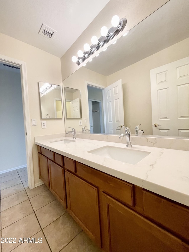 bathroom with tile patterned flooring and vanity