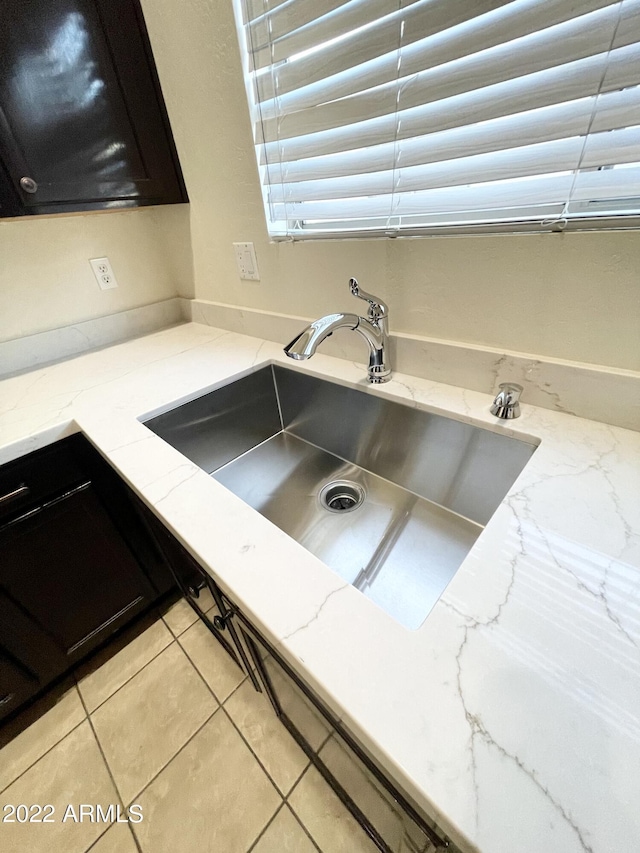 room details featuring sink and light stone counters