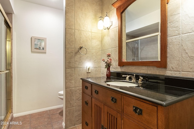 bathroom with toilet, walk in shower, and vanity