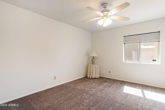 unfurnished room with ceiling fan and carpet