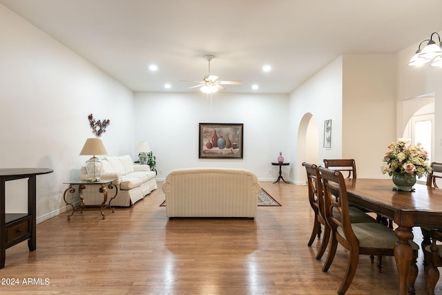 dining space with ceiling fan and light hardwood / wood-style flooring