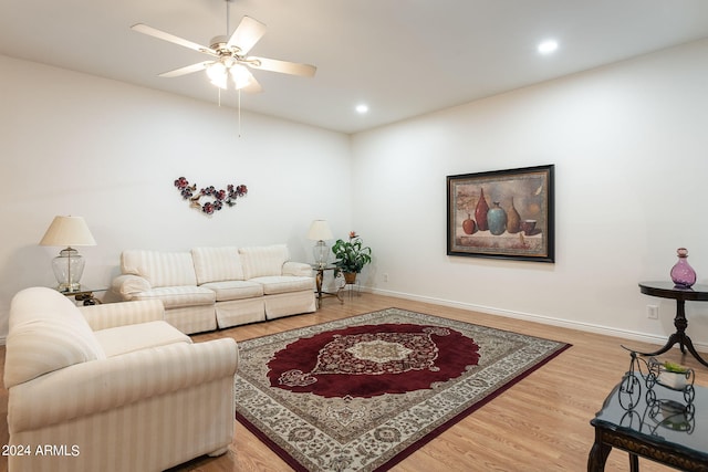 living room with hardwood / wood-style flooring and ceiling fan