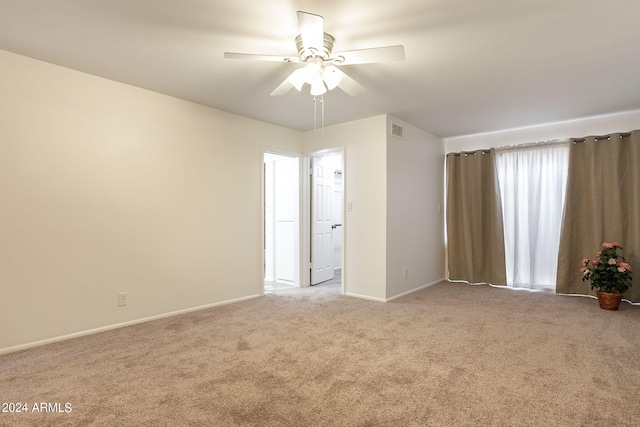 unfurnished room featuring light carpet and ceiling fan