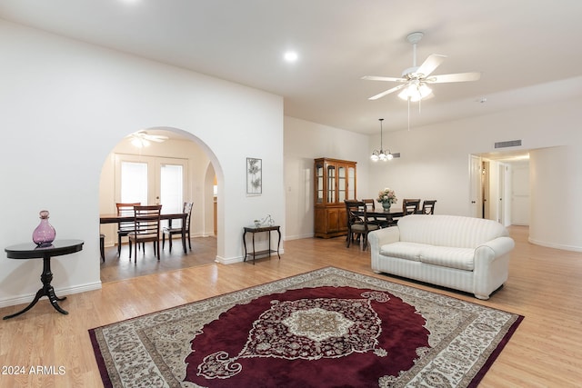 living room with ceiling fan and hardwood / wood-style floors