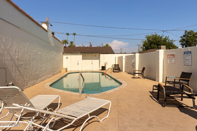 view of swimming pool with a patio area