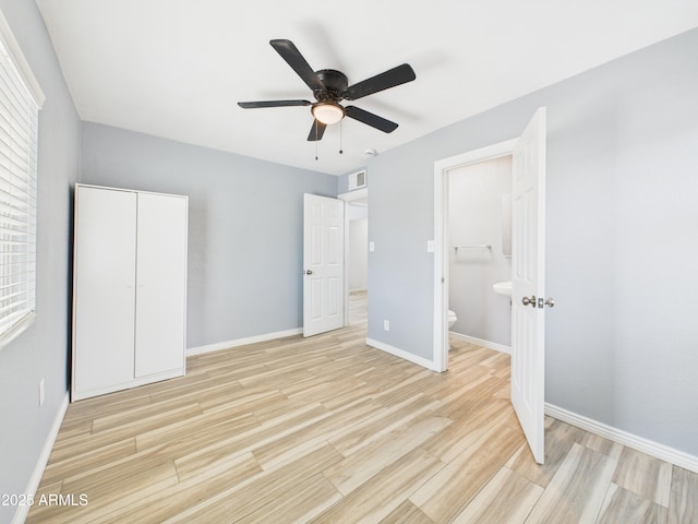2628 W Marshall Ave, Phoenix, AZ 85017 - unfurnished bedroom featuring light wood finished floors, ensuite bath, a ceiling fan, and baseboards