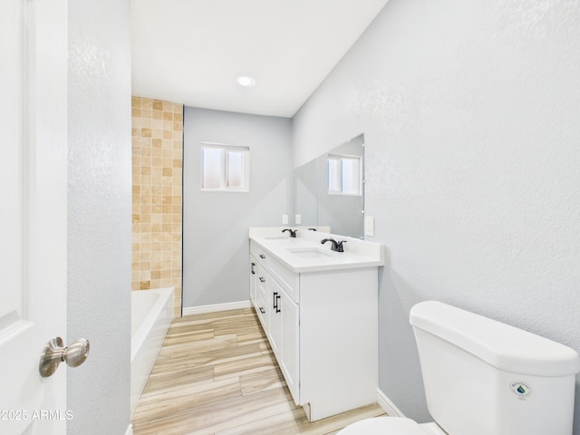 2628 W Marshall Ave, Phoenix, AZ 85017 - full bathroom featuring toilet, vanity, and wood finished floors
