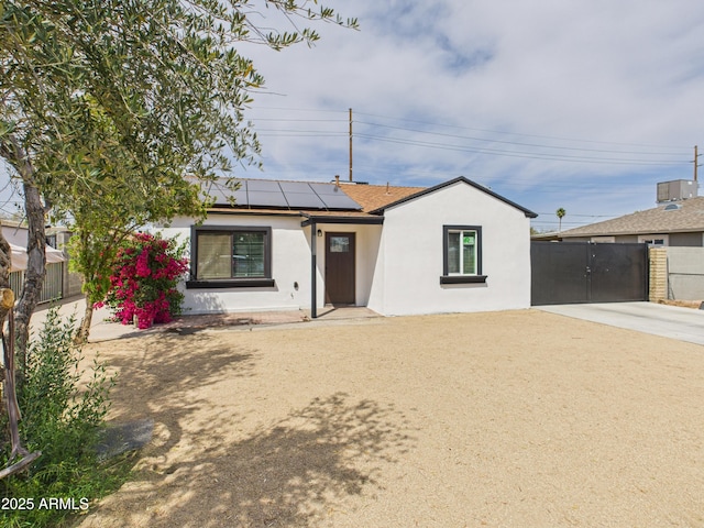 2628 W Marshall Ave, Phoenix, AZ 85017 - ranch-style home featuring roof mounted solar panels, driveway, stucco siding, and fence