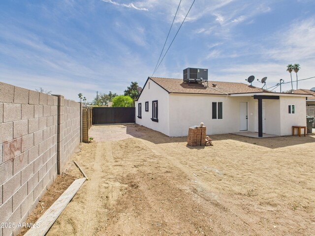 2628 W Marshall Ave, Phoenix, AZ 85017 - back of property with a fenced backyard, central air condition unit, roof with shingles, and stucco siding