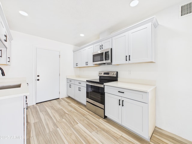 2628 W Marshall Ave, Phoenix, AZ 85017 - kitchen featuring visible vents, recessed lighting, light countertops, a sink, and stainless steel appliances