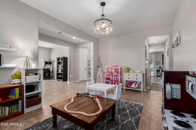 game room with tile patterned floors, baseboards, and an inviting chandelier