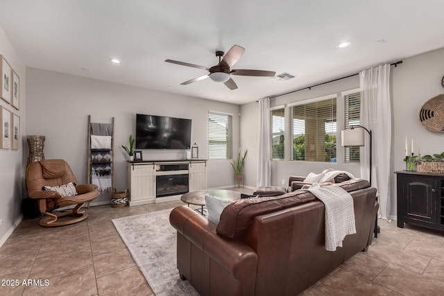 living area featuring visible vents, baseboards, ceiling fan, tile patterned floors, and recessed lighting