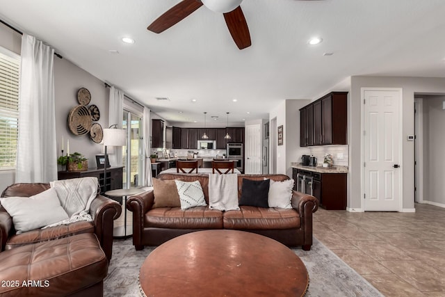 living room featuring a ceiling fan, recessed lighting, a healthy amount of sunlight, and light tile patterned flooring