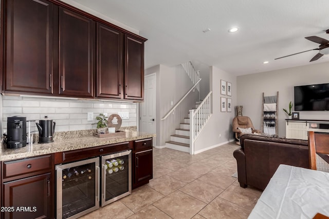 kitchen featuring open floor plan, beverage cooler, a ceiling fan, and decorative backsplash