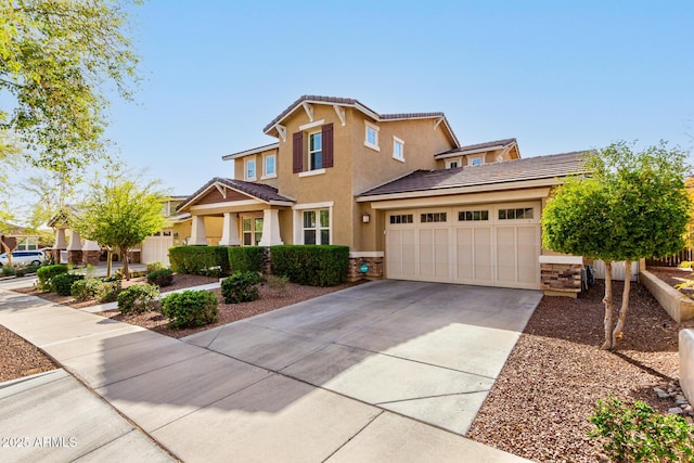 view of front of home featuring a garage, stone siding, concrete driveway, and stucco siding