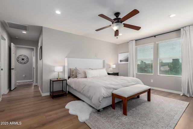 bedroom featuring light wood-style flooring, visible vents, and baseboards