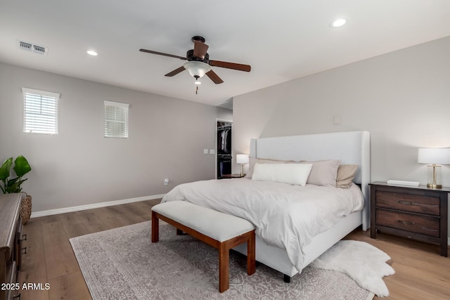 bedroom featuring light wood-style flooring, visible vents, baseboards, and recessed lighting