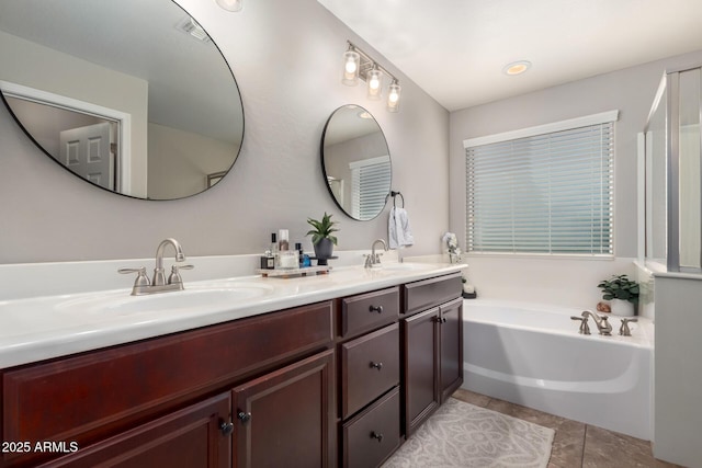 bathroom featuring tile patterned floors, visible vents, a sink, and a bath