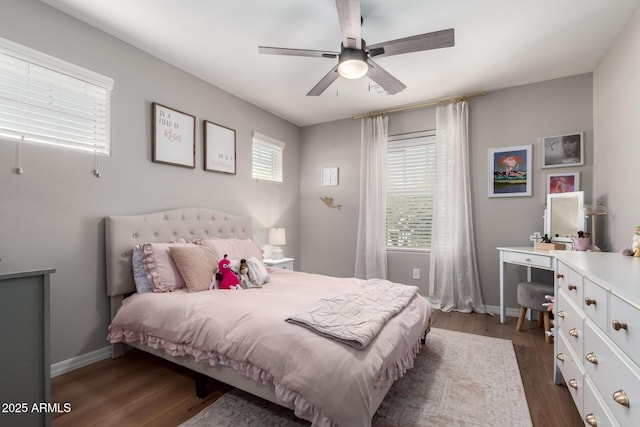 bedroom with dark wood-style floors, ceiling fan, and baseboards