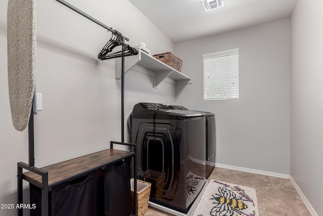 laundry area featuring baseboards, laundry area, visible vents, and washer and dryer