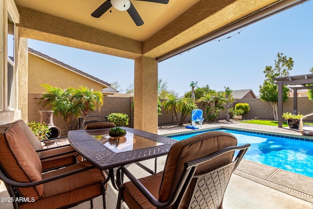 view of swimming pool with outdoor dining space, a fenced backyard, ceiling fan, and a patio