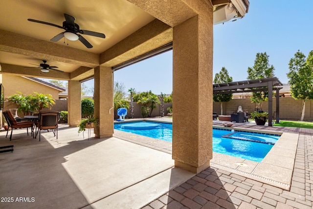 view of swimming pool with a patio area, a fenced backyard, a pool with connected hot tub, and a ceiling fan