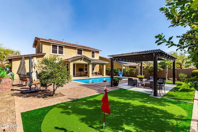 back of property with a fenced in pool, a patio, stucco siding, a pergola, and a fenced backyard