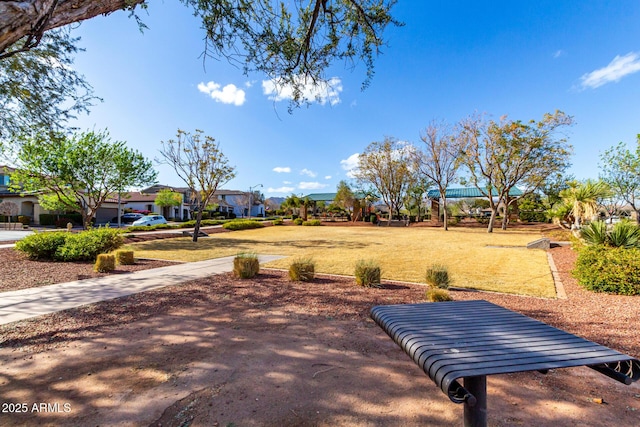 view of home's community featuring a lawn and a residential view