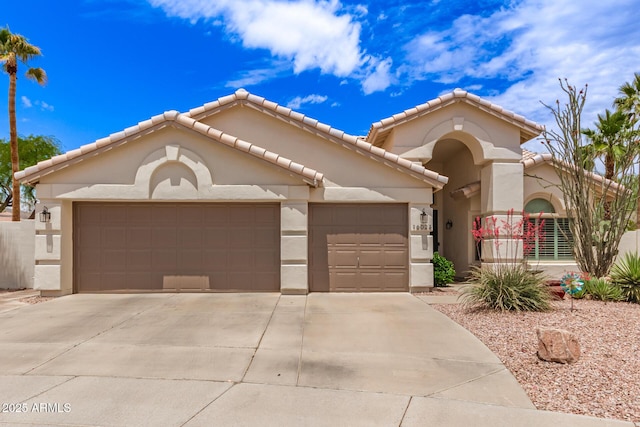 16023 S 30th Pl, Phoenix, AZ 85048 - mediterranean / spanish house with a tiled roof, stucco siding, concrete driveway, and an attached garage