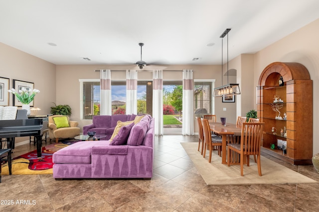 living room with a ceiling fan and visible vents