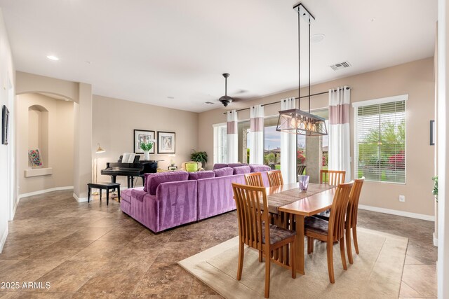 dining area featuring arched walkways, a ceiling fan, baseboards, recessed lighting, and visible vents