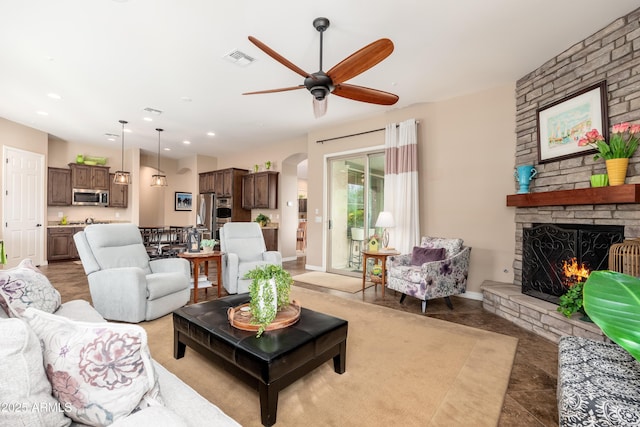 living area with visible vents, a fireplace, ceiling fan, recessed lighting, and arched walkways