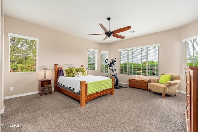 carpeted bedroom with baseboards, a ceiling fan, and visible vents